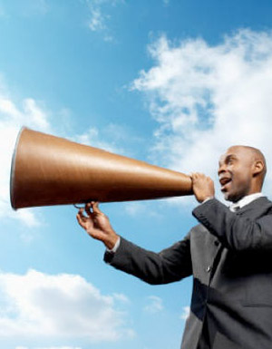 Picture of businessman screaming in bullhorn