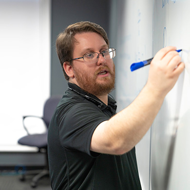 professor writing on marker board