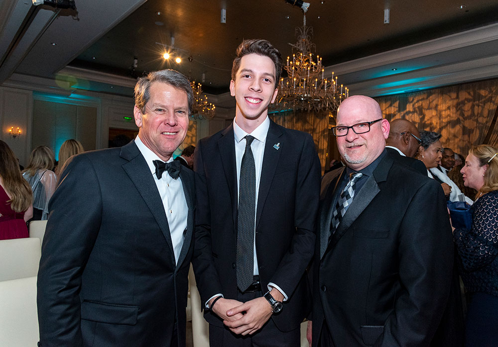 Governor Brian Kemp, Gabe Bello a student at Columbus State University and President Chris Markwood, Columbus State University.