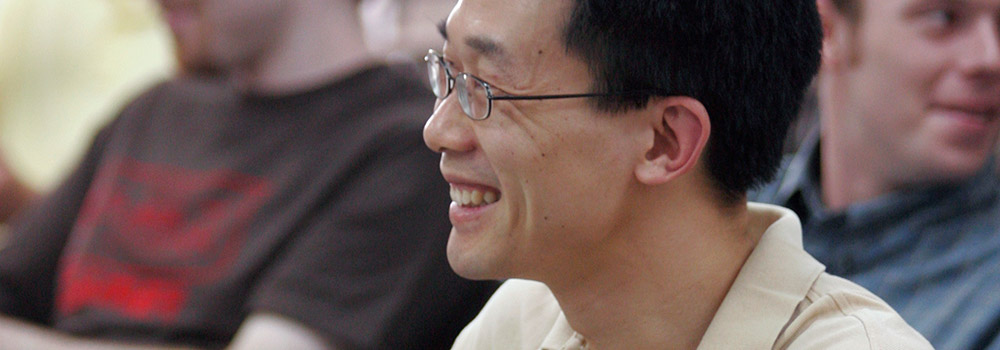 student smiling in classroom sitting at desk