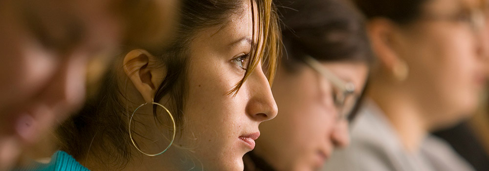 students sitting in classroom listening to professor